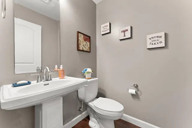 a bathroom with a sink mirror and toilet