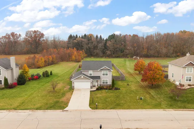 a bird view of residential house with pool
