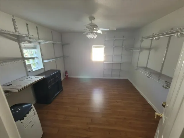 a view of a swimming pool with a yard and plants