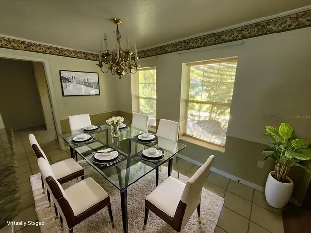 a spacious bedroom with a bed a couch and large windows