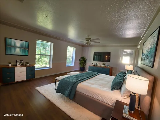 a bedroom with a bed and a potted plant