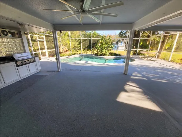 a view of a fountain in front of a house with large trees
