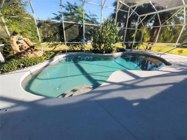 an aerial view of a house yard swimming pool and outdoor seating
