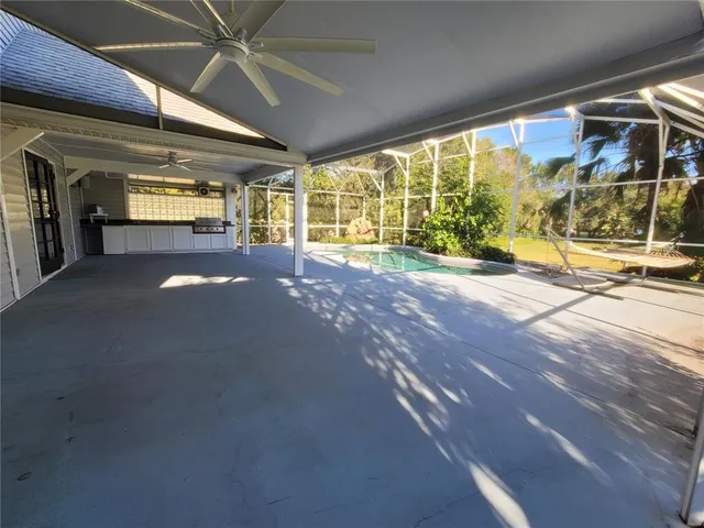 an aerial view of a house with swimming pool and garden view