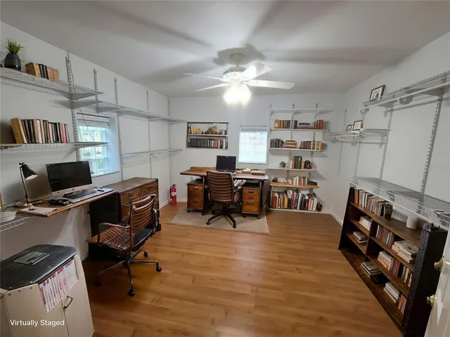 a spacious bedroom with a bed and a flat screen tv