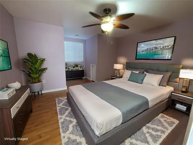 a dining room with furniture a flat screen tv and a floor to ceiling window