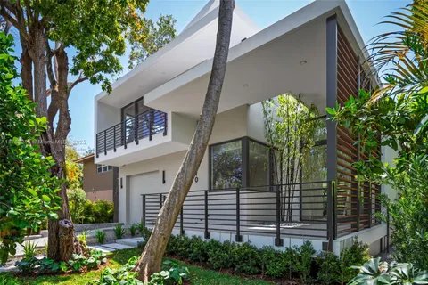 a view of a house with a flower garden