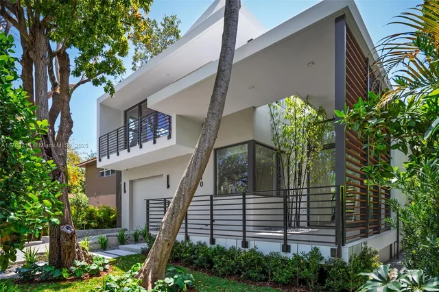 a view of a house with a flower garden