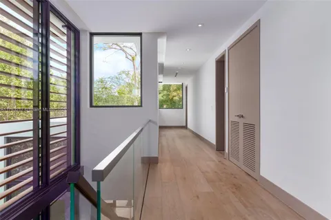 a view of room with wooden floor and doors