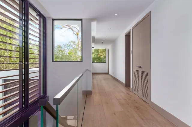 a view of room with wooden floor and doors