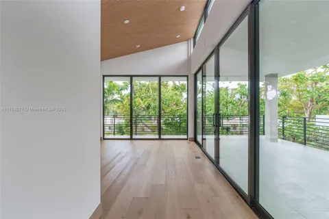 a view of an empty room with glass door