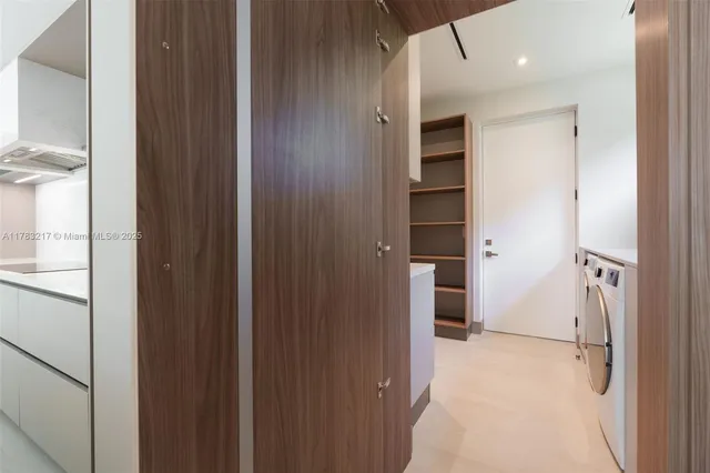 a kitchen with cabinets and a refrigerator