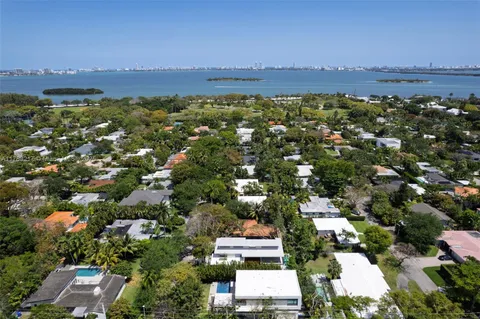 an aerial view of residential houses with outdoor space and parking