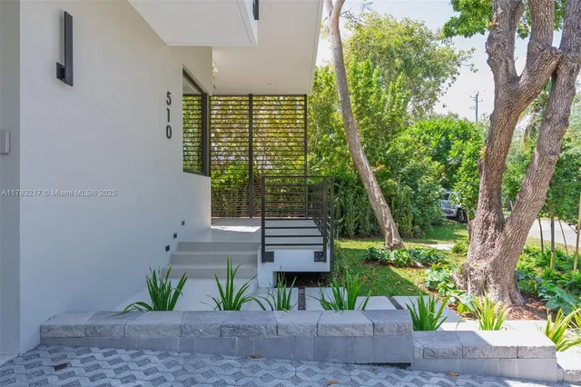 a front view of a house with garden