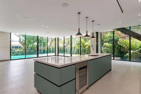 a view of hallway with stairs and wooden floor
