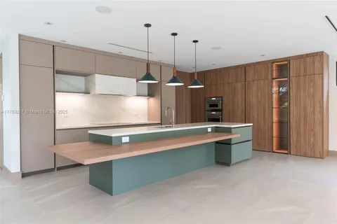 a view of hallway with a large window and wooden floor