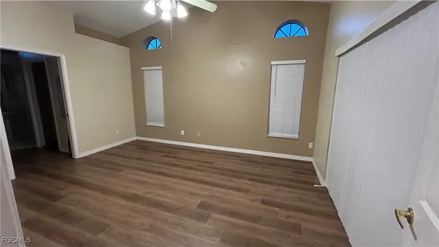 an empty room with wooden floor and door