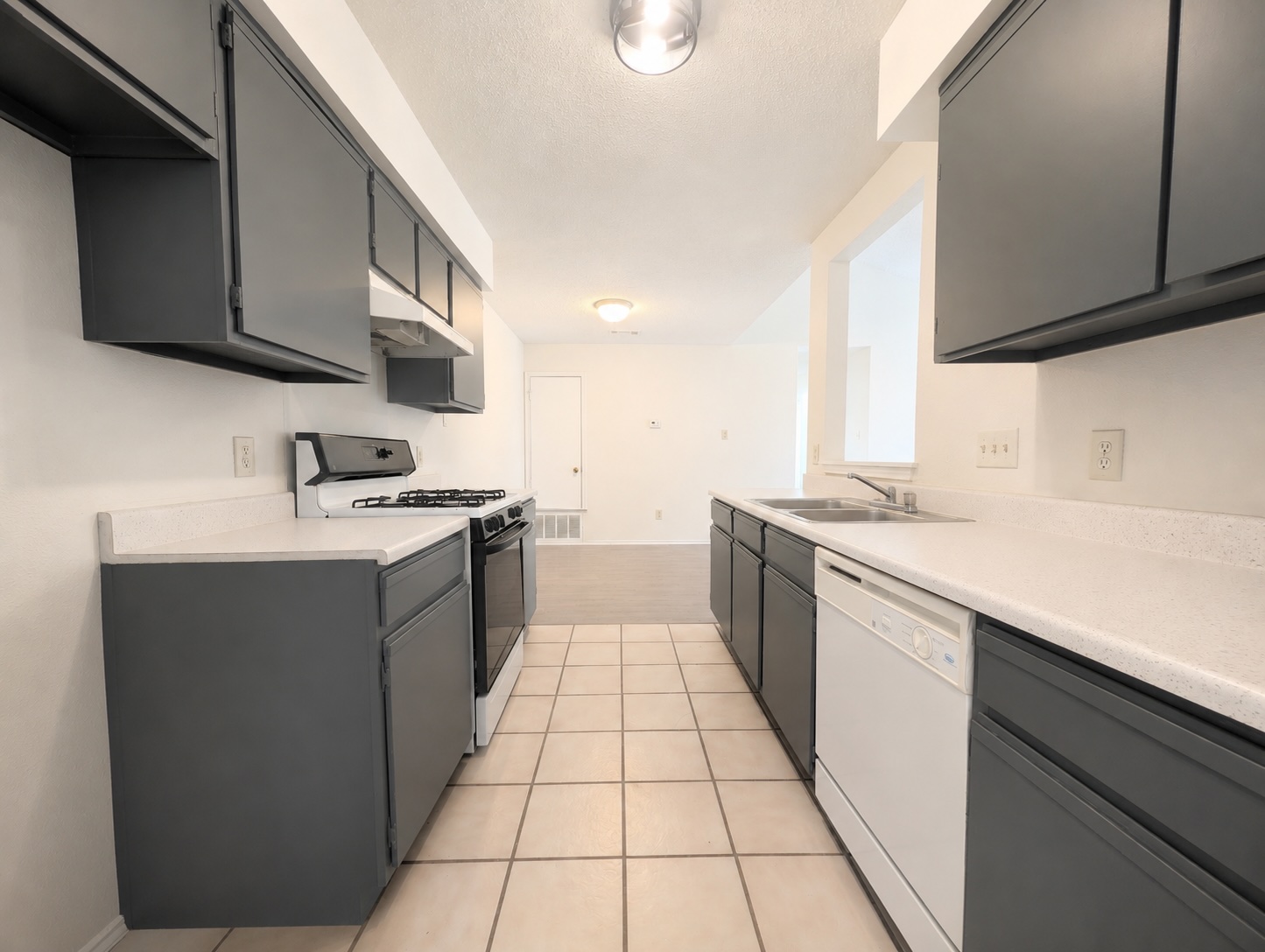 2016 Redwing Way Round Rock, TX 78664 - Photo 5 of 19 A well-appointed kitchen featuring sleek dark cabinetry and practical appliances awaits culinary endeavors.