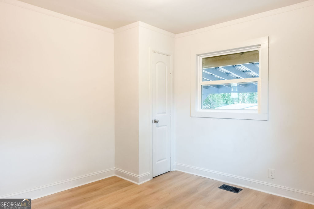 80 Menefee Street Palmetto, GA 30268 - Photo 21 of 30 a view of an empty room with wooden floor and a window