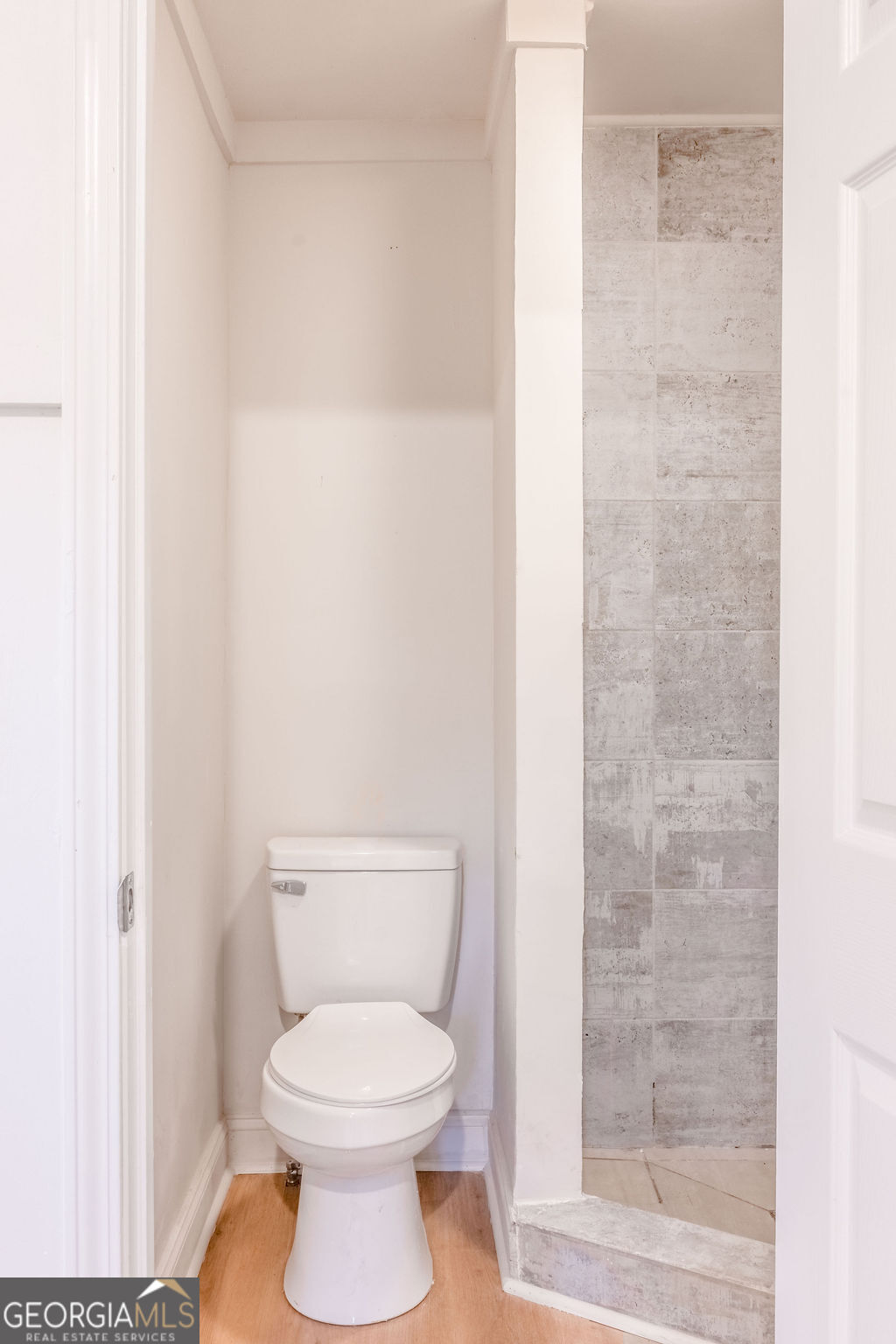 80 Menefee Street Palmetto, GA 30268 - Photo 24 of 30 a white toilet sitting next to a shower