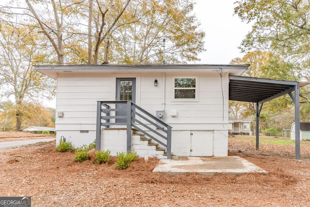 80 Menefee Street Palmetto, GA 30268 - Photo 27 of 30 a white house that has a tree in front of it