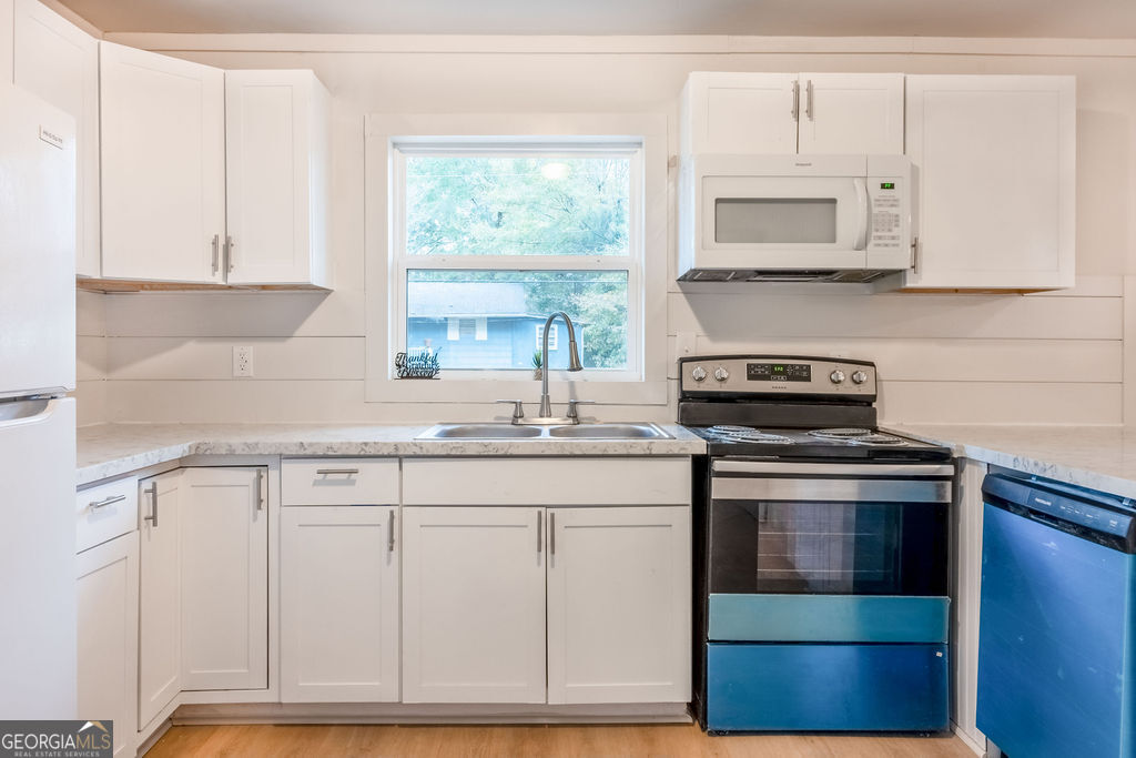 80 Menefee Street Palmetto, GA 30268 - Photo 10 of 30 a kitchen with white cabinets appliances and a sink