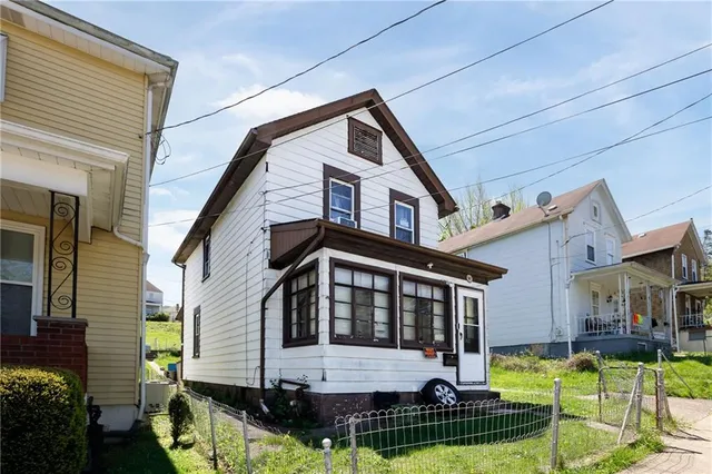 a front view of house with yard outdoor seating and garage