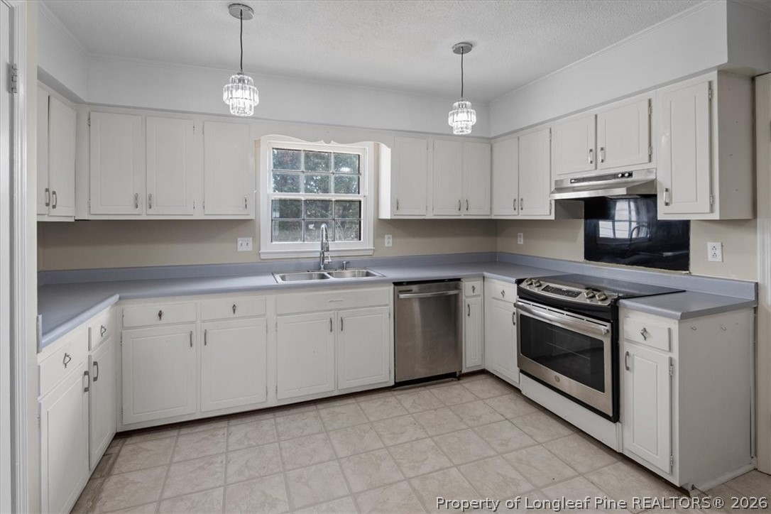 630 Bedford Road Fayetteville, NC 28303 - Photo 8 of 21 a kitchen with granite countertop white cabinets white stainless steel appliances with a sink and dishwasher