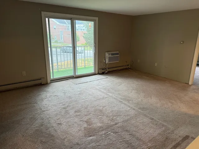 a view of an empty room with a fireplace