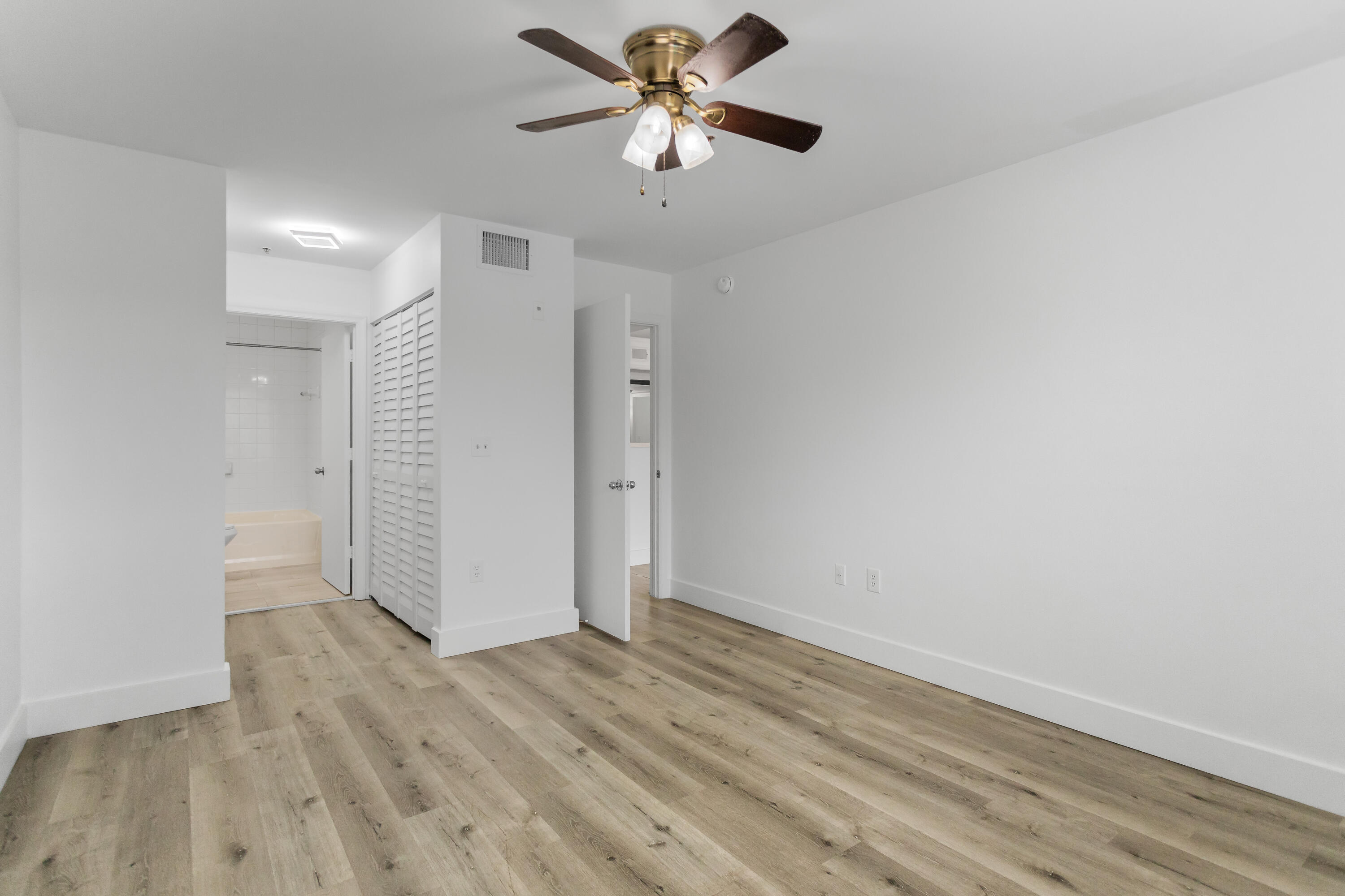 2113 Renaissance Boulevard, Unit 306 Miramar, FL 33025 - Photo 39 of 59 a view of a room with wooden floor and a ceiling fan