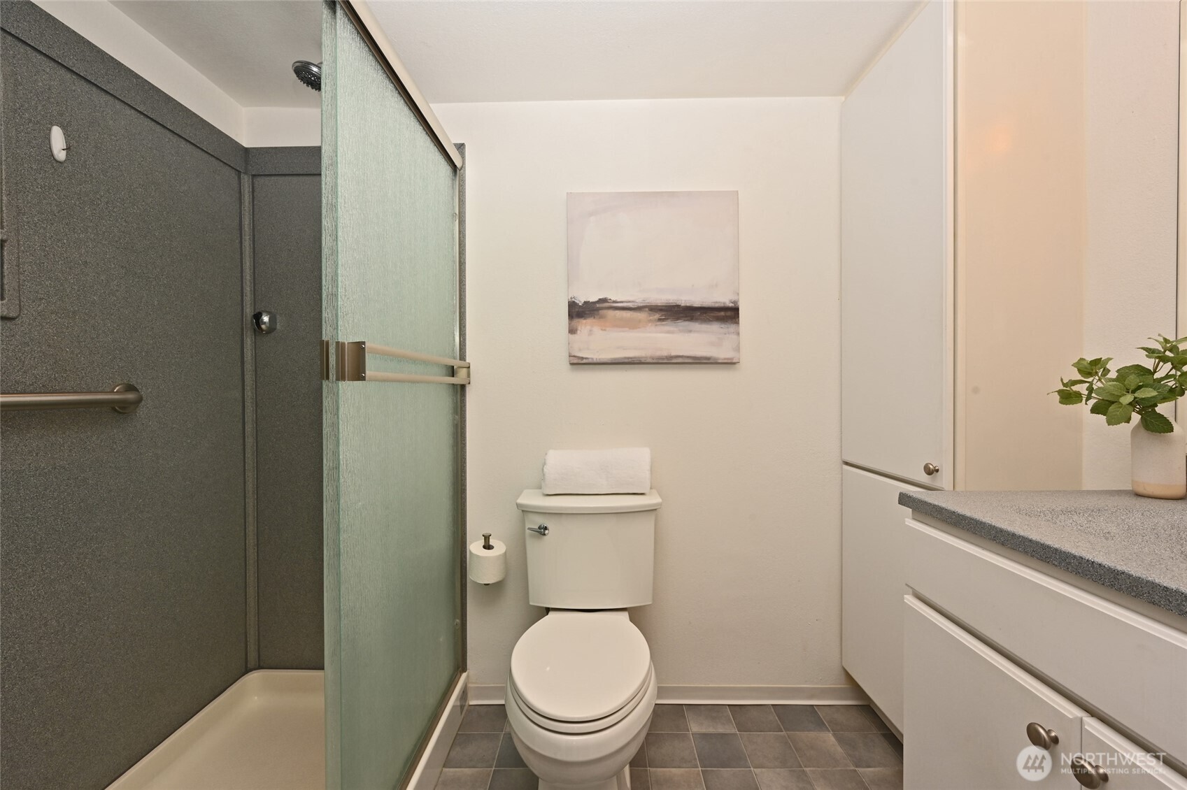 3421 Southwest Roxbury Street, Unit 401 Seattle, WA 98126 - Photo 12 of 22 a white toilet sitting next to a bathroom sink