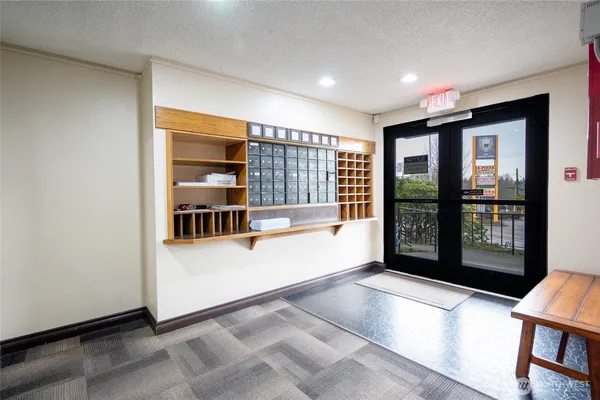 a view of an entryway with wooden floor and door