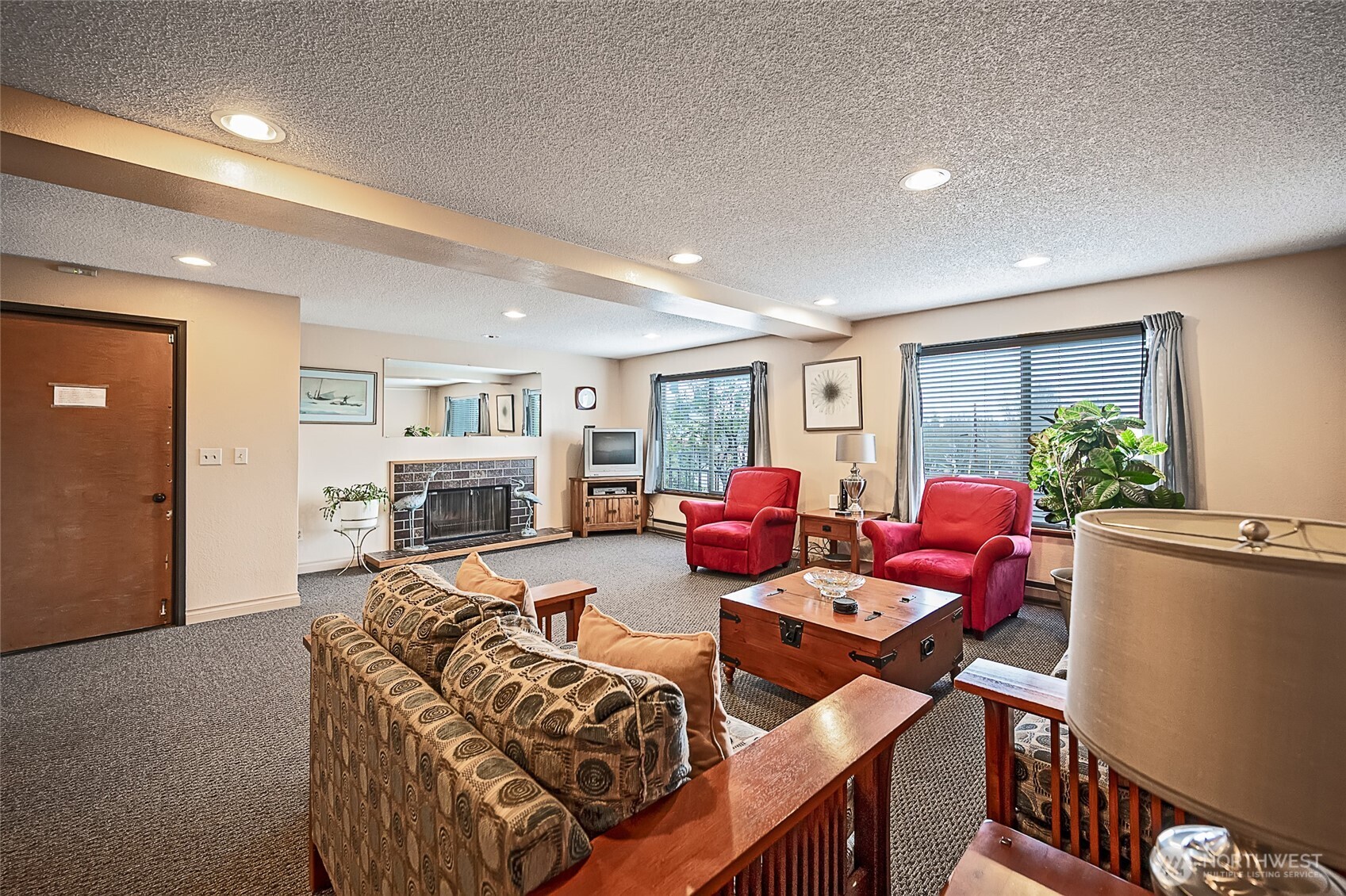 3421 Southwest Roxbury Street, Unit 401 Seattle, WA 98126 - Photo 18 of 22 a living room with furniture fireplace and a large window