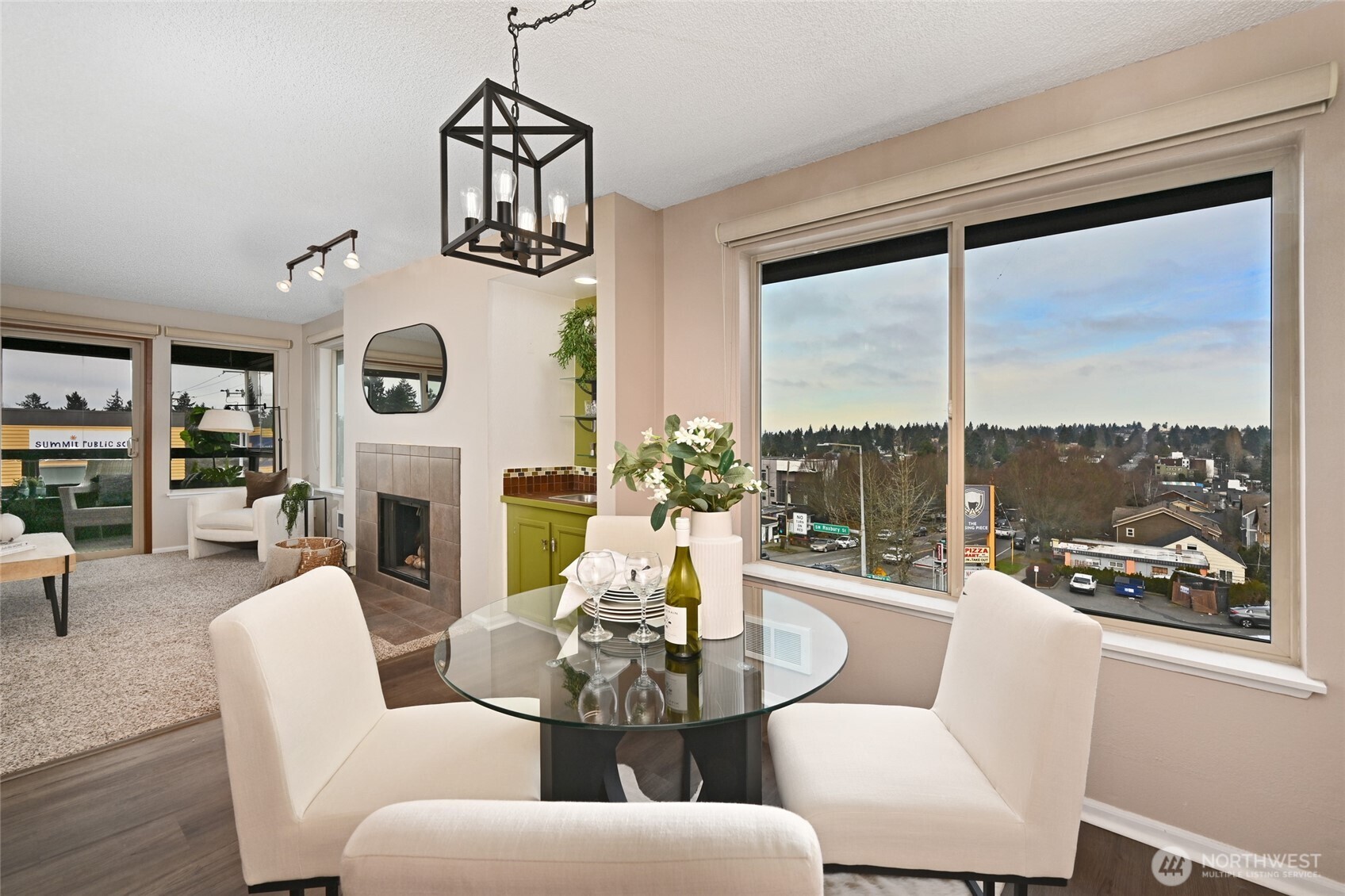 3421 Southwest Roxbury Street, Unit 401 Seattle, WA 98126 - Photo 6 of 22 a living room with furniture a fireplace and a large window