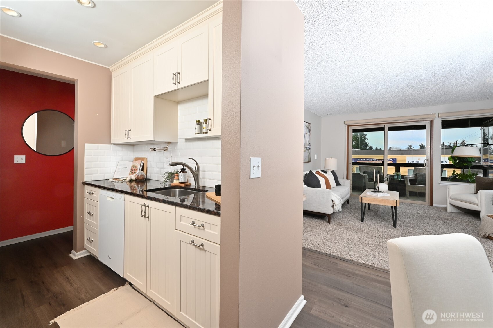 3421 Southwest Roxbury Street, Unit 401 Seattle, WA 98126 - Photo 7 of 22 a kitchen with granite countertop a sink and a stove with wooden floor