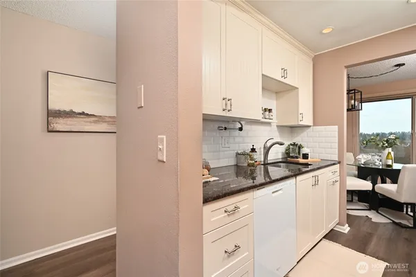 a kitchen with stainless steel appliances granite countertop a sink stove and cabinets