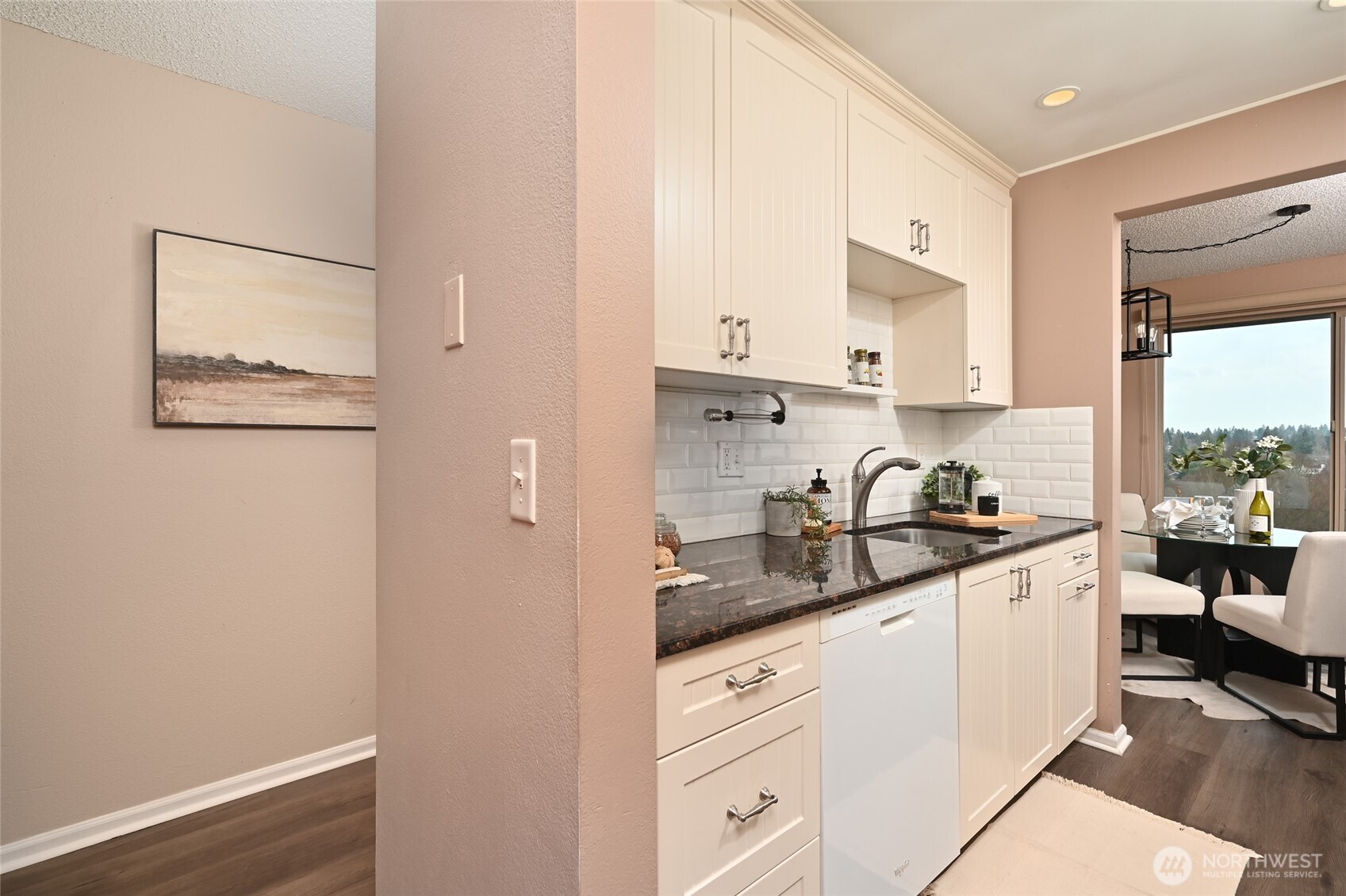 3421 Southwest Roxbury Street, Unit 401 Seattle, WA 98126 - Photo 8 of 22 a kitchen with stainless steel appliances granite countertop a sink stove and cabinets