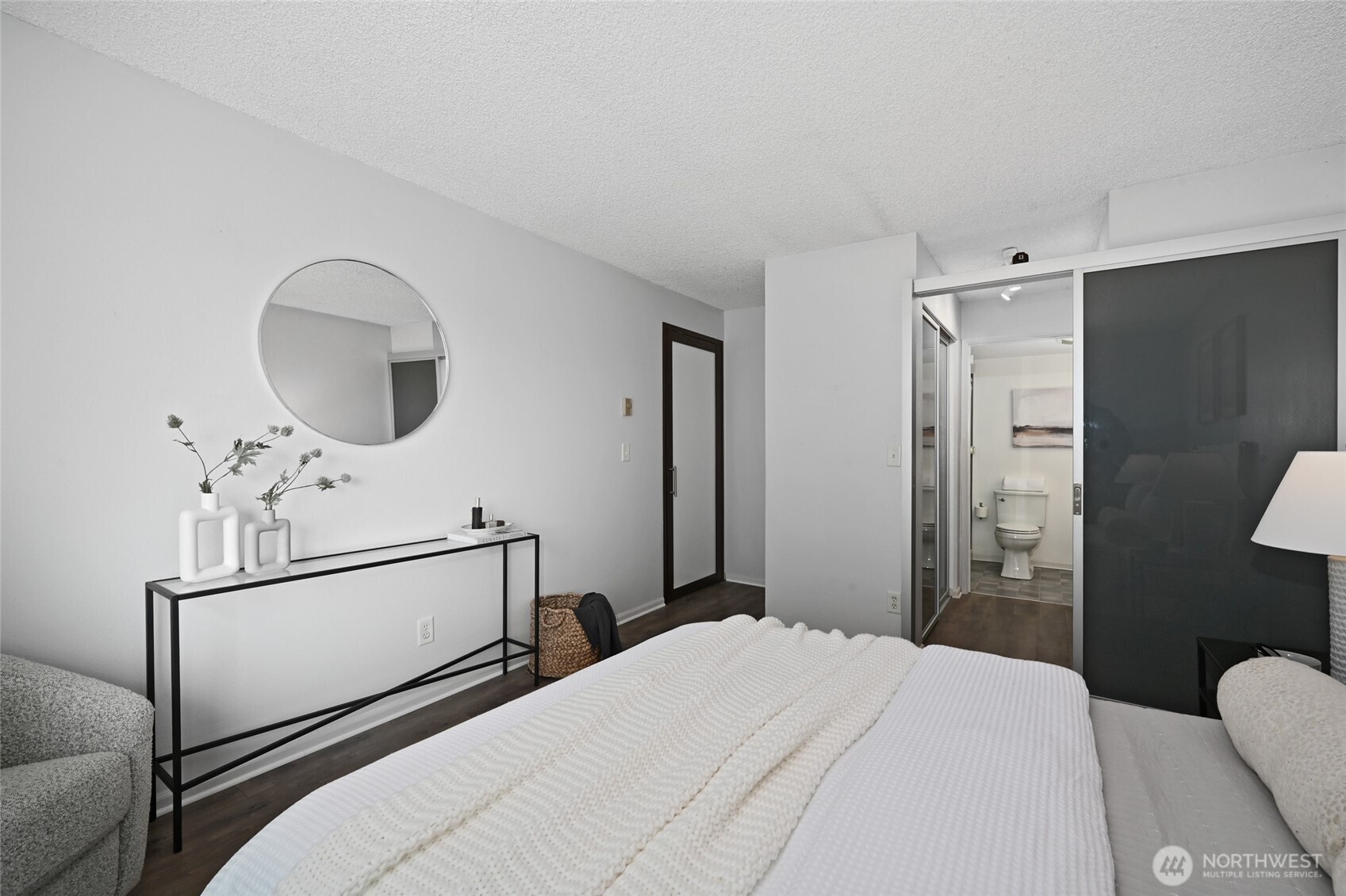 3421 Southwest Roxbury Street, Unit 401 Seattle, WA 98126 - Photo 10 of 22 a bedroom with a bed a mirror and a shower