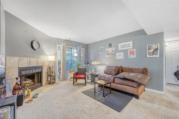 a living room with furniture and a fireplace