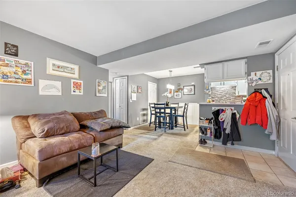 a living room with furniture a air conditioner and a rug
