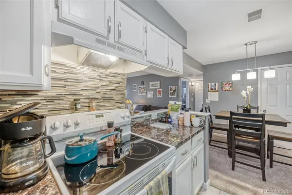a kitchen with stainless steel appliances granite countertop a sink and cabinets