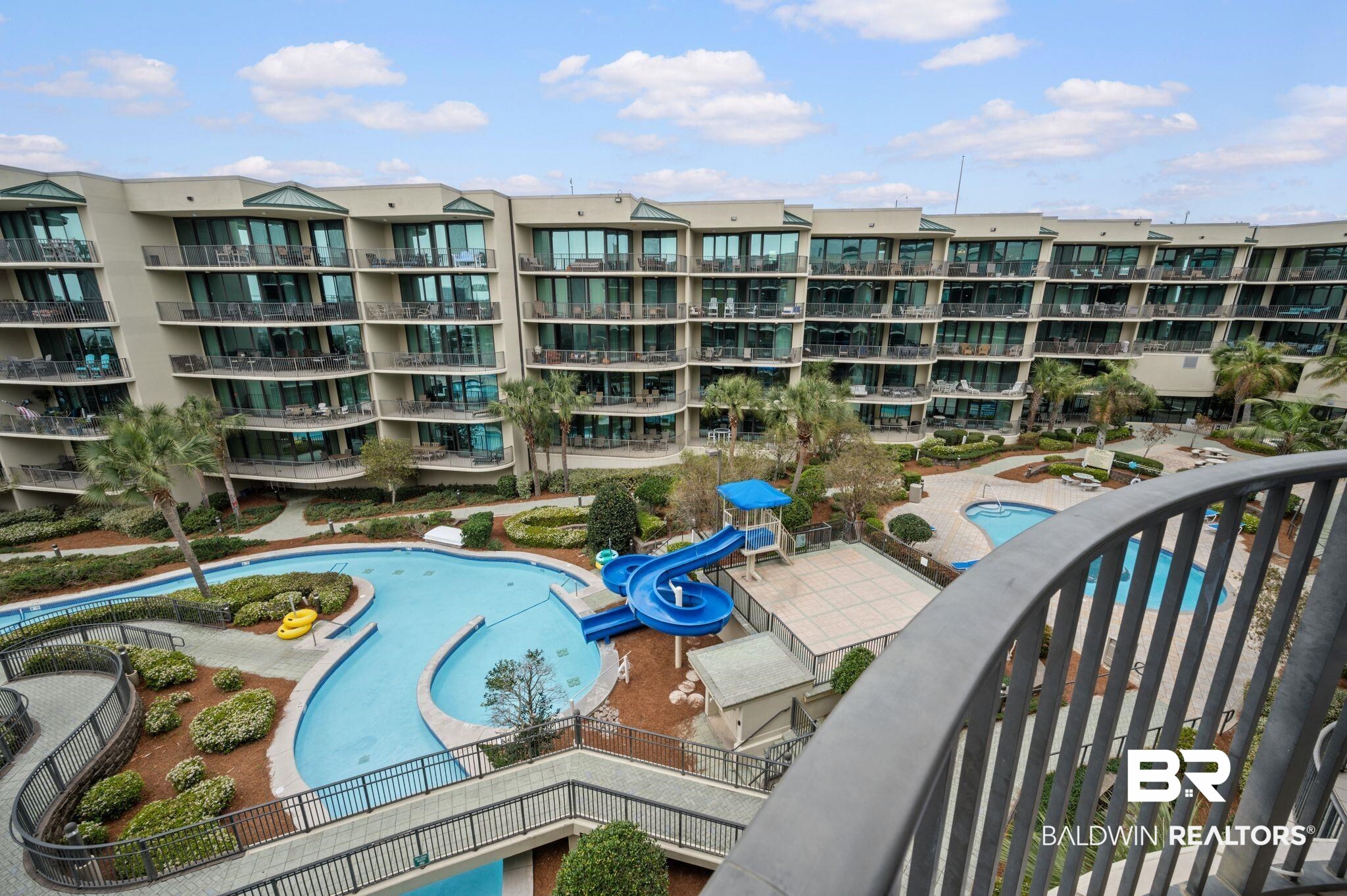 27580 Canal Road, Unit 1427 Orange Beach, AL 36561 - Photo 33 of 38 Community pool featuring a balcony and a water slide