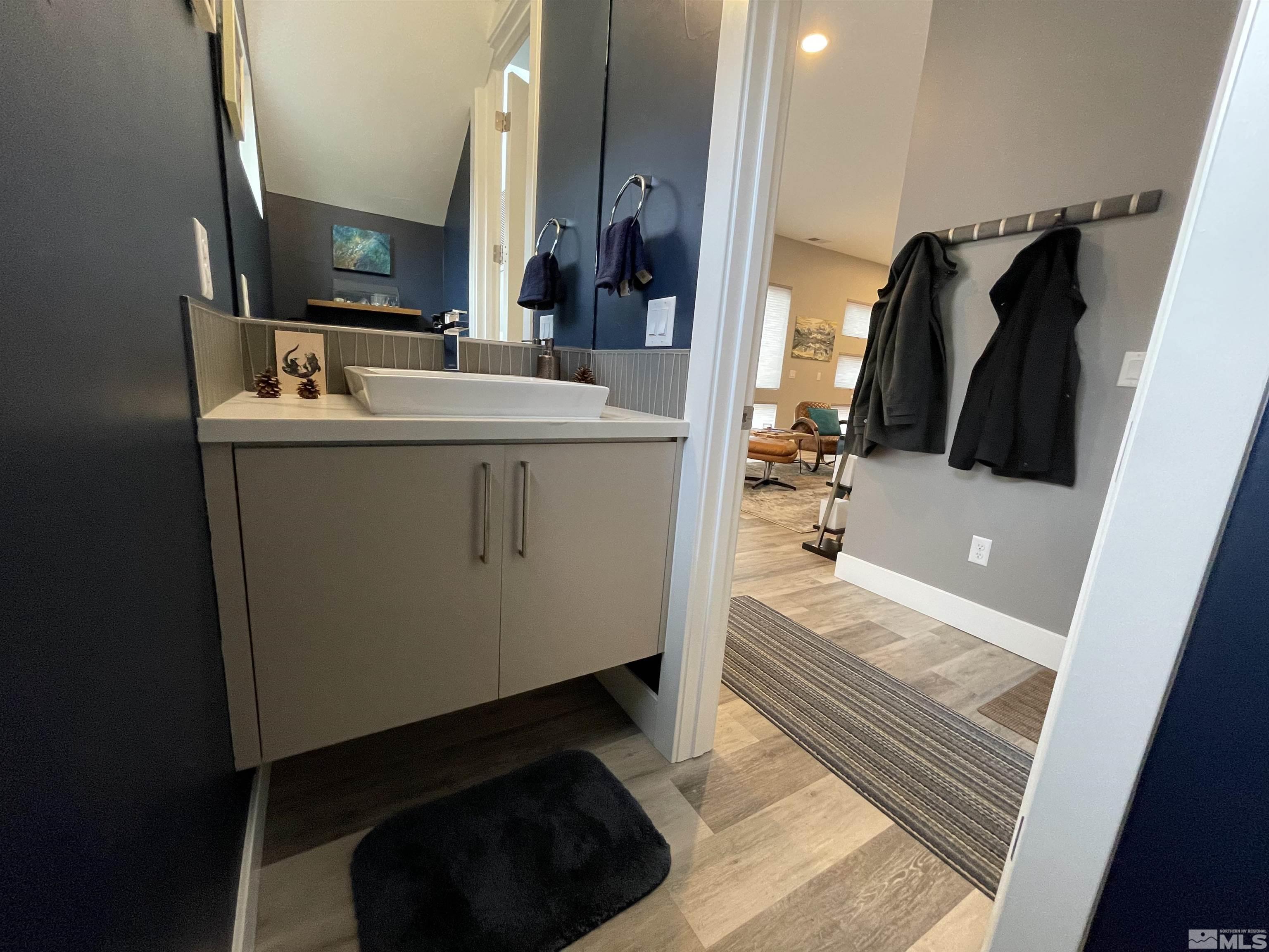 123 Martin Street Reno, NV 89509 - Photo 11 of 31 a bathroom with a sink a mirror and a bathtub