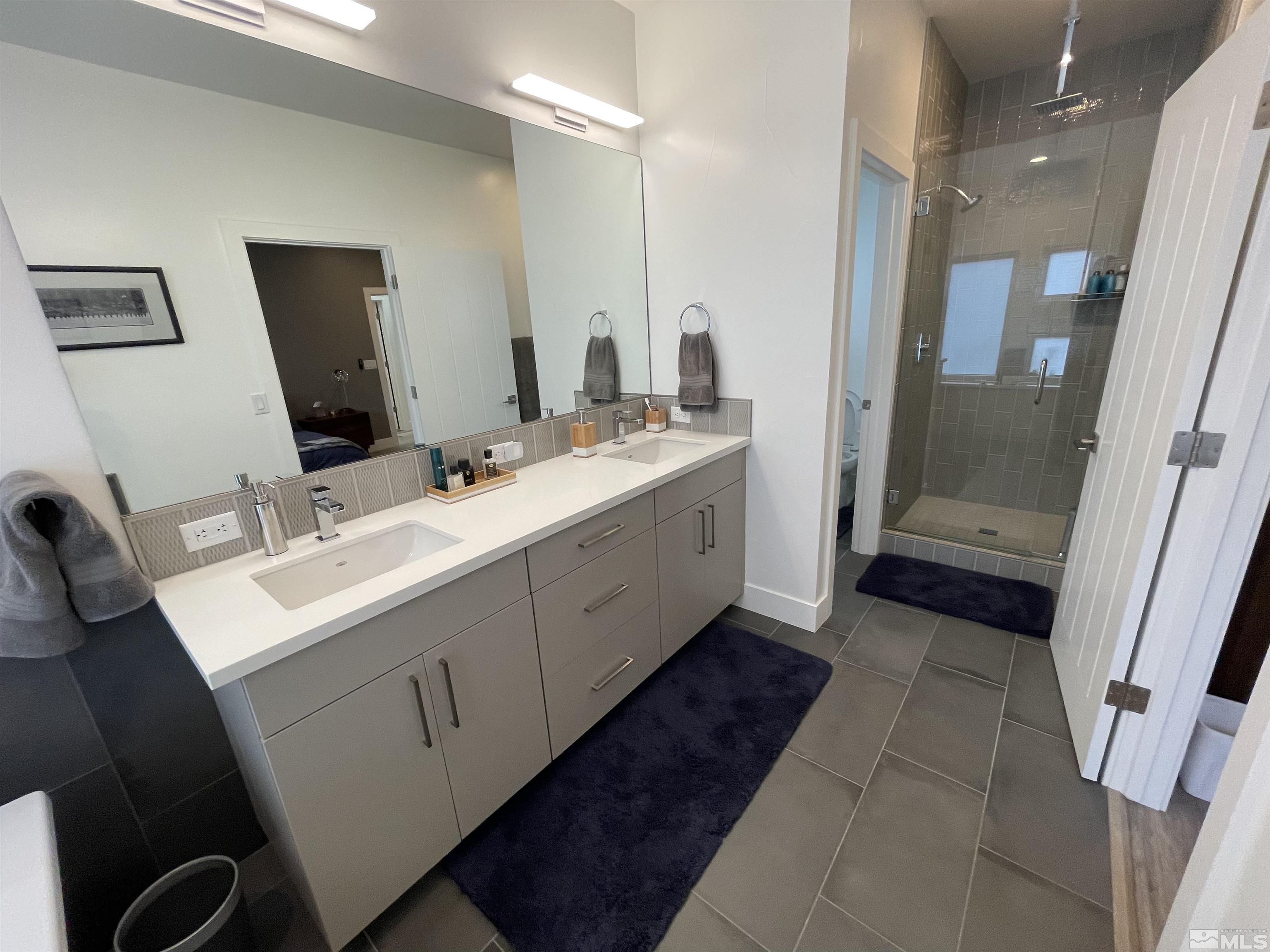 123 Martin Street Reno, NV 89509 - Photo 20 of 31 a bathroom with a double vanity sink a and mirror