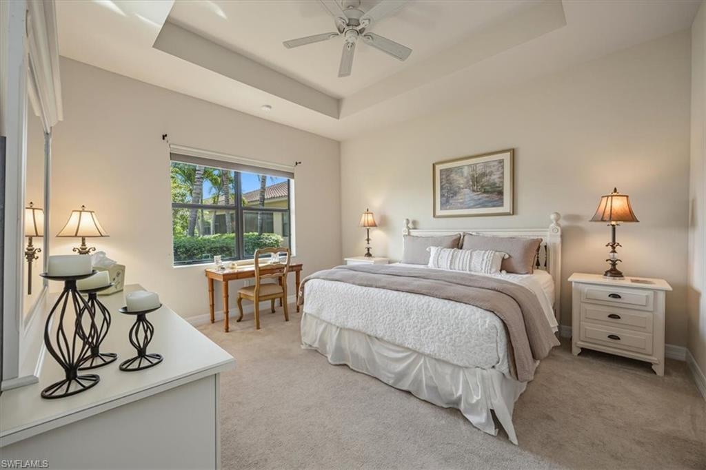 13466 Sumter Lane Naples, FL 34109 - Photo 12 of 36 Bedroom with light colored carpet, a raised ceiling, and a ceiling fan