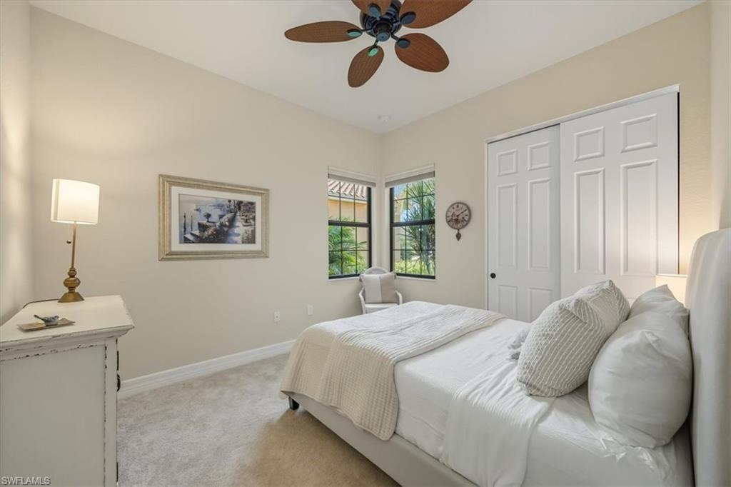 13466 Sumter Lane Naples, FL 34109 - Photo 15 of 36 Bedroom with carpet floors, a ceiling fan, and a closet