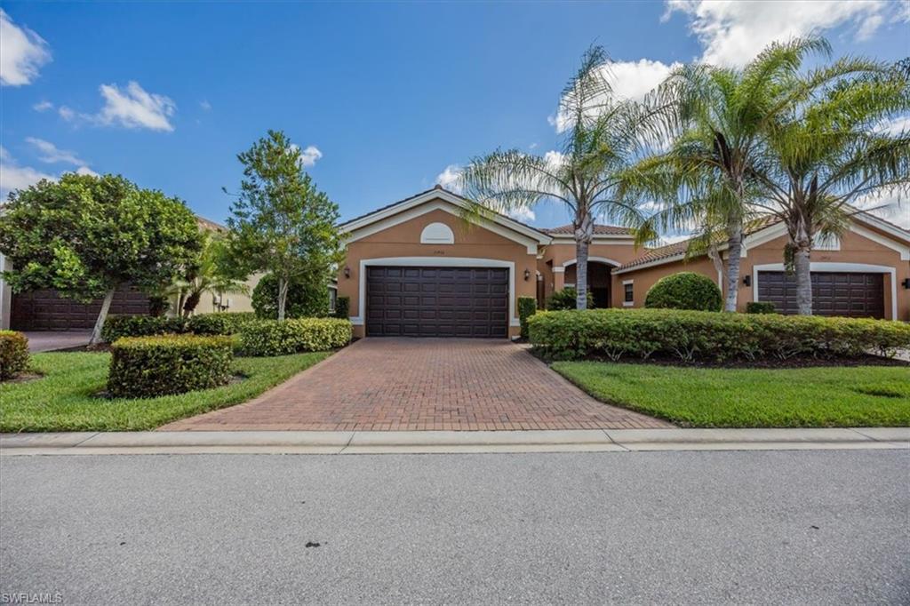 13466 Sumter Lane Naples, FL 34109 - Photo 2 of 36 View of front of home featuring stucco siding, a garage, and decorative driveway