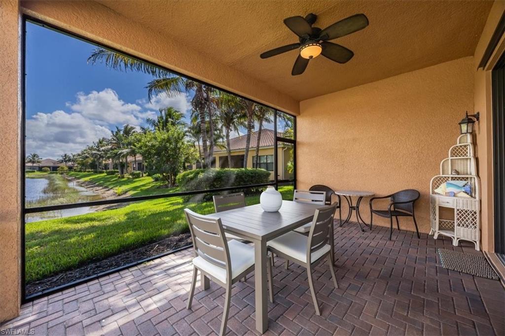 13466 Sumter Lane Naples, FL 34109 - Photo 21 of 36 Sunroom / solarium with outdoor dining space, a ceiling fan, a water view, and a patio area