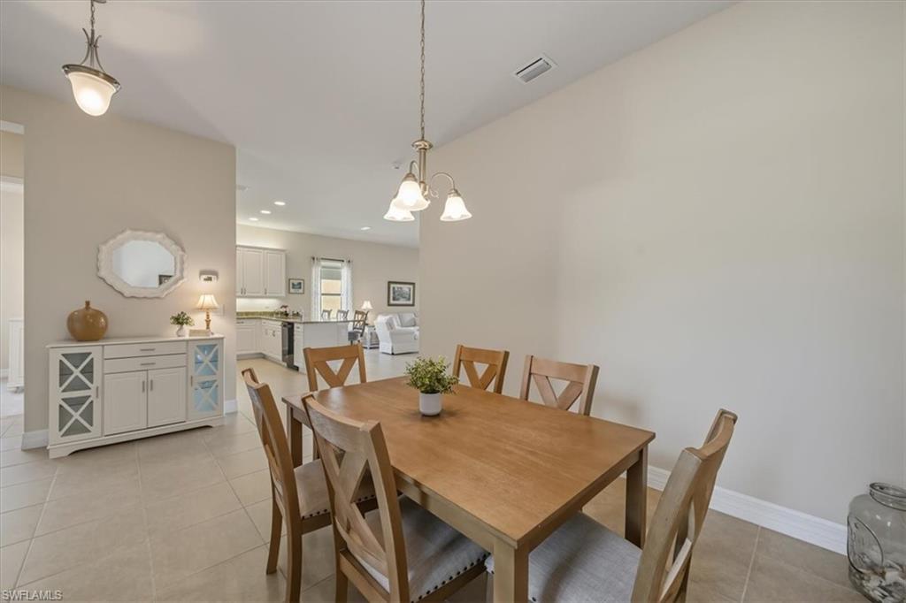 13466 Sumter Lane Naples, FL 34109 - Photo 10 of 36 Dining room featuring light tile patterned floors, recessed lighting, and a chandelier