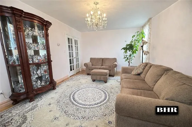 a living room with furniture and a chandelier